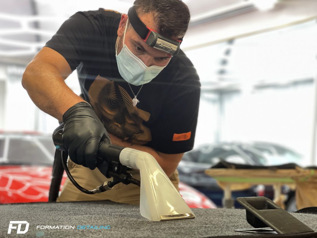 Stagiaire utilisant un injecteur-extracteur sur une moquette